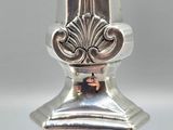 an image of a silver vase sitting on top of a table