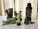 a lot of figurines sitting on a table next to each other