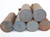 a pile of old metal barrels stacked on top of each other