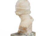marble bust of a man with a hat on top of a marble block