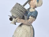 a figurine of a woman with a bird on her shoulder