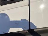 a shadow of a person on the side of a white truck