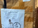 a brown bag with a sticker on it sitting on a chair