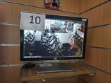un écran d'ordinateur posé sur un bureau en bois