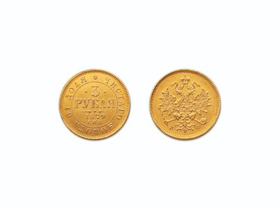 gros plan de deux pièces d'or sur une surface blanche