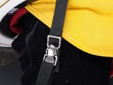 a close up of a yellow and black backpack with a black strap