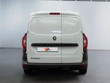 the rear end of a white van parked in a garage