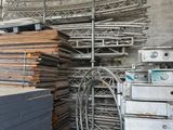 a large pile of wood in a warehouse with a conveyor belt in the foreground