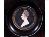 an old picture of a woman in a black dress in a black frame