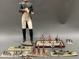 a figurine of a man standing in front of a bunch of toy soldiers