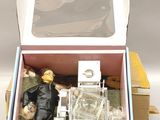 a box with a doll inside of it on a table