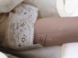 a close up of a doll ' s legs with a tattoo on it