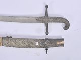 two knives that are laying next to each other on a table