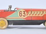 a red toy car with a dog sitting in it