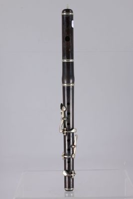 a close up of a black and silver clarinet on a clear surface