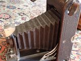 an old camera sitting on a rug on the floor