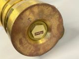 a close up of a brass object on a white surface