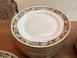 many plates that are sitting on a wooden table