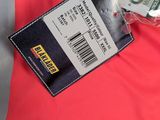 a red shirt with a tag on it next to a wallet