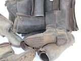 many pairs of boots and a purse on the ground