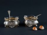 pair of silver plated salt and pepper shakers with spoons