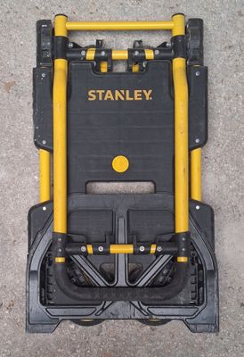 a black and yellow tool cart with two yellow handles
