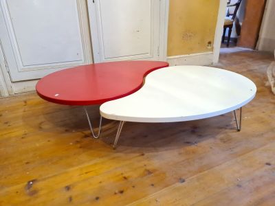 two red and white tables sitting on a wooden floor