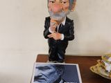 a figurine of a man in a tuxedo on a table