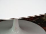 a white table with a white base and a white table top