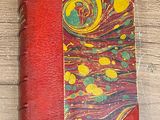 a red book with yellow and green designs on it
