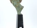 sculpture of a bust of a man on a black pedestal