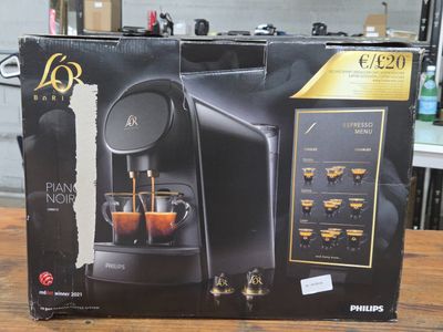 the box of the coffee machine is open on the table