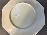 a white plate that has a blue and white design on it