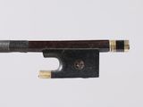a close up of a violin bow on a white surface