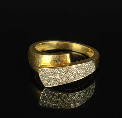 a close up of a gold ring on a black surface