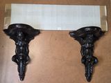 two wall sconces that are on the wall