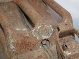 an old rusted piece of luggage sitting on top of a table