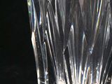 a clear glass vase sitting on a black surface