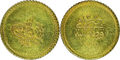 a gold coin with arabic writing on it