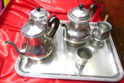 a silver tray with a silver tea set on it