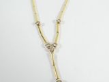 a close up of a necklace on a white surface with a white background