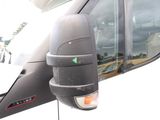 a side view mirror of a truck that is parked in a lot