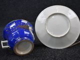 a cup and saucer sitting next to each other on a table