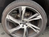 a black car with a flat tire on the street