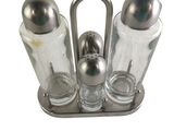 three salt and pepper shakers in a metal holder