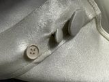 a close up of a button on a white shirt