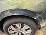 a close up of a car ' s front tire with a denting on it