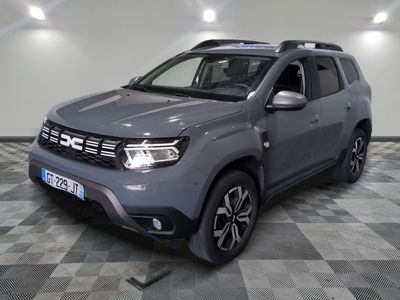the grey dacia is parked on a checkered tile floor
