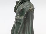 statue of a man in a top hat and coat with a cane