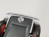 a close up of a toy car with wheels on a white surface